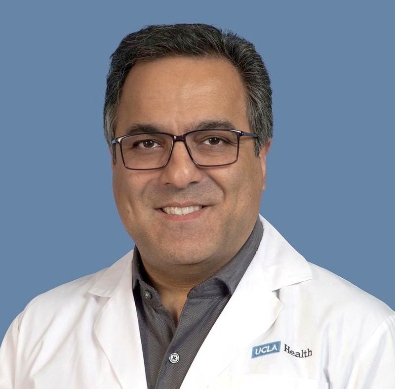 Dr. Kasra Navabi in his white coat at UCLA Health